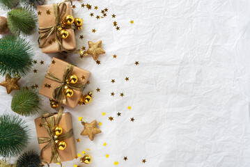 Gold Christmas theme decorations on paper texture background,  Christmas tree, gold presents box, decorative gold stars and Christmas ball. 