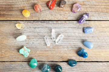 Aura. Different natural mineral stones on wooden table, flat lay