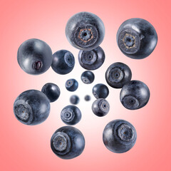 Fresh ripe blueberries swirling in air against coral gradient background