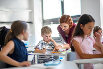 Teacher talking with children in primary class.