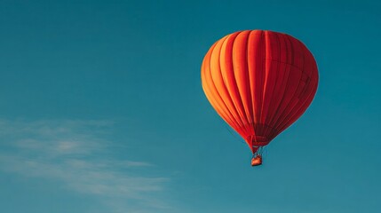 Fototapeta premium Red hot air balloon against clouds