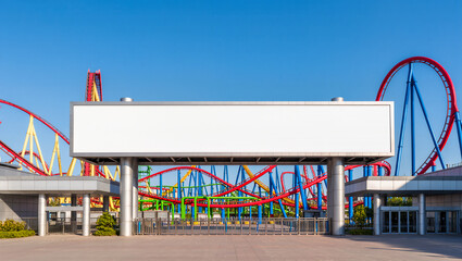 A large blank horizontal billboard stands at the entrance to an amusement park with a roller coaster in the background. The empty space is a perfect mockup for park promotions, event schedules, or tic