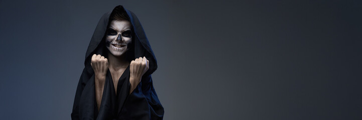 Smiling Skull-Like Character in Hooded Cloak Wide Banner