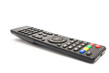 Close-up of a sleek black universal remote control on a pristine white surface