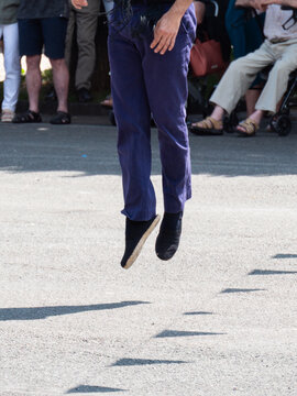 Traditional Basque dance captured mid-jump in Zarautz
