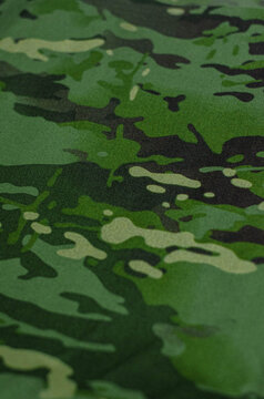 Detail of green multicam camo nylon textile, commonly used for industrial uniforms and outdoor gear.