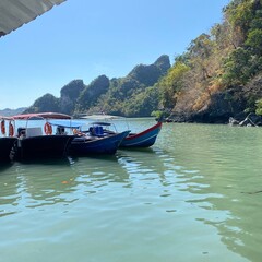 Colorful Boats Docked in Calm Tropical Bay Surrounded by Lush Hills