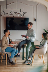 Business team discussing strategy using digital tablet in modern office