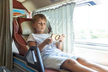 Child, boy, traveling in a sleeper bus in Vietnam, bed seat in the bus, kid on vacation summer
