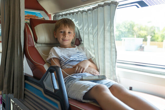 Child, boy, traveling in a sleeper bus in Vietnam, bed seat in the bus, kid on vacation summer