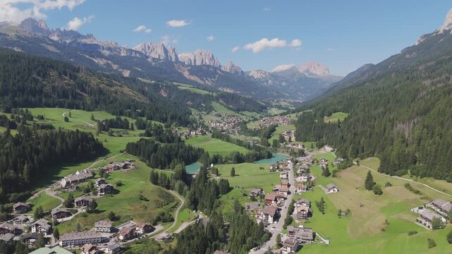 Amazing aerial orbit over picturesque alpine valley of Val di Fassa, Moena, Dolomites, Trentino, Italy.