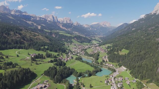 Amazing aerial view of Val di Fassa beautiful valley and alpine environment, Moena, Dolomites, Trentino, Italy.
