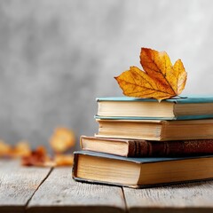 Stacked vintage books with colorful autumn leaves on top, resting on a rustic wooden table, creating a cozy and inviting atmosphere for reading and reflection