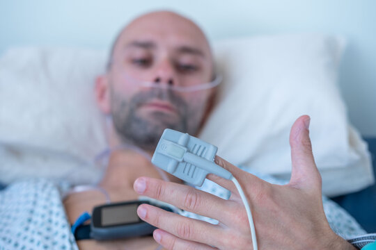 Patient finger with Pulse oximeter monitoring oxygen saturation level monitoring, finger sensor medical device, SpO2 measurement, EMS stimulator, healthcare technology, medical examination equipment