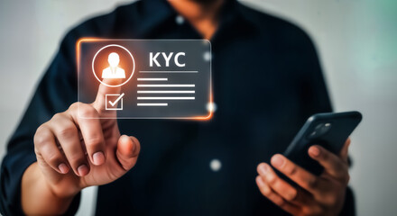 Man holding a smartphone and touching a virtual screen displaying kyc know your customer identity verification process, emphasizing digital security and personal data validation in finance , business