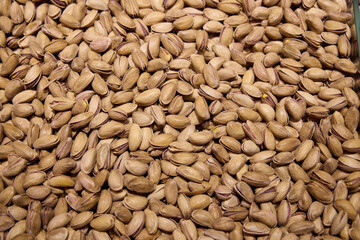 The varied texture of shelled pistachios and nuts creates a delightful background
