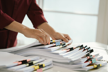 A cluttered office desk filled with paperwork, documents, files, and reports, symbolizing heavy workload, financial management, research, business tasks, corporate responsibilities, stress, and organi