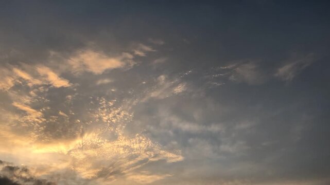 Time lapse footage of golden clouds in the afternoon sky, showing warm tones, soft light, and dynamic cloud movement that creates a serene and cinematic natural scene.