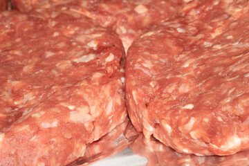 Close up of raw burgers waiting to be fry cooked beef meat