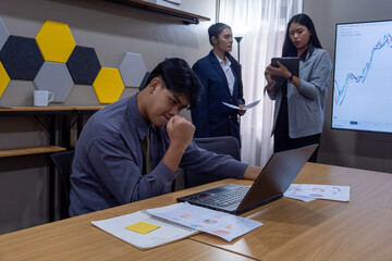 Team members discuss strategies while analyzing financial data in a modern office setting