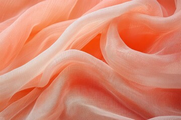 Obraz premium Close-up view of a soft, flowing, peachy-orange fabric with a subtle ombre effect.