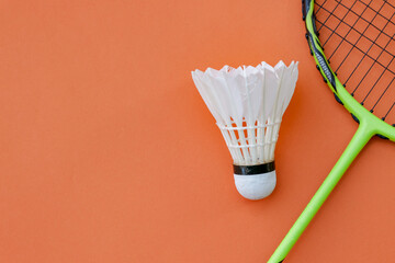 Shuttlecock and Racket on Orange Background