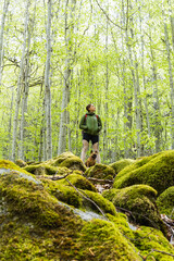 Naklejka premium Active young woman going hiking with dog