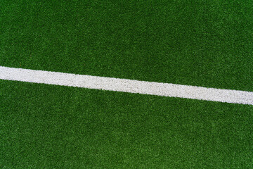 the line on a perfect green grass in soccer stadium.