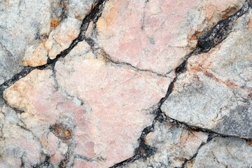 Close-up view of a fractured rock face showcasing a blend of light gray, beige, and pinkish hues.