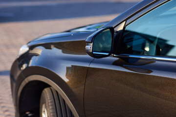 An elegant closeup shot of a sleek car side mirror showcasing its design and details