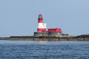 Red and white lighthouse on the Farne Islands, Northumberland, UK
