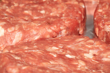 Close up of raw burgers waiting to be fry cooked beef meat