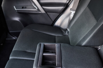 Obraz premium Vehicle armrest with cup holder, beige design, for luxury cars