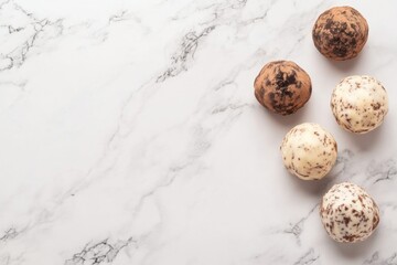Obraz premium Artisan Truffle Delights: A stunning top-down composition of decadent truffles artfully arranged on a refined marble surface, celebrating the indulgence of confectionery artistry.