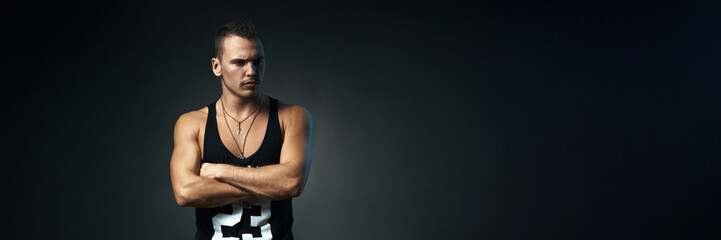 Fototapeta premium Serious Man in Dark Setting, Wide Banner with Copy Space