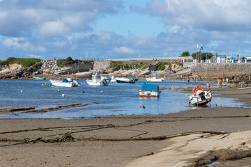 Santander, Spain. La Maruca beach with boats stranded on the sand at low tide under the summer sun