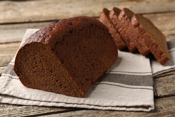 Pieces of fresh rye bread on wooden table, closeup