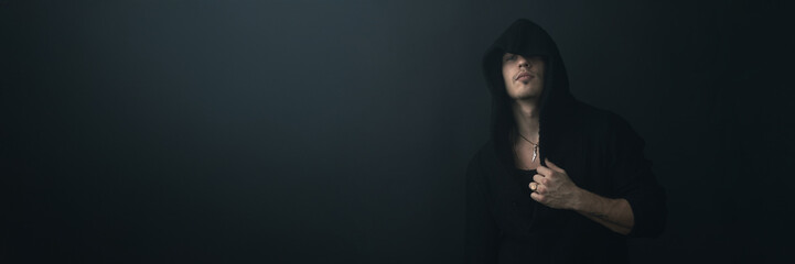 Mysterious Hooded Man Portrait Wide Banner with Copy Space