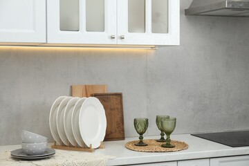Clean dishware and glasses on countertop in kitchen