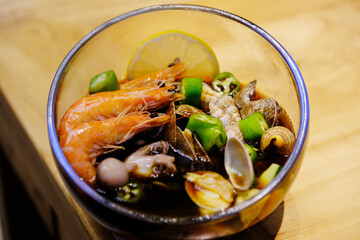 Marinated seafood with shrimp, shellfish, snails. Chinese food