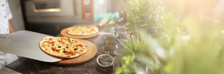 Fresh Pizza in Kitchen with Copy Space Wide Banner