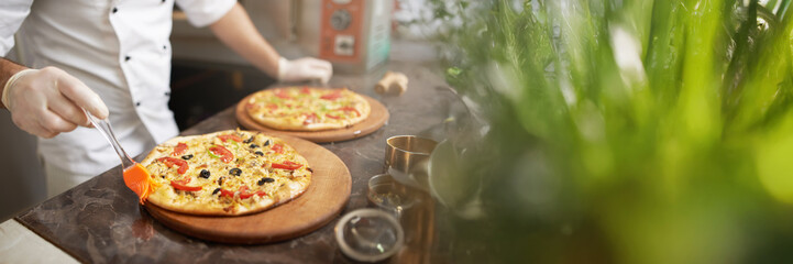 Chef Preparing Pizzas in Wide Banner with Copy Space