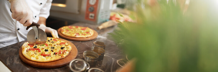 Chef Slicing Pizza with Copy Space Wide Banner