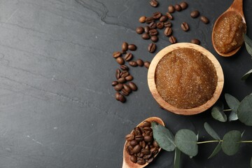 Natural body scrub, coffee beans and eucalyptus leaves on black table, flat lay. Space for text