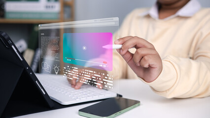 Online learning, education technology, innovation, and future digital interface in modern classroom. Boy using digital pen with holographic screen and tablet computer.