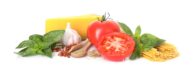 Raw spaghetti pasta and different ingredients isolated on white