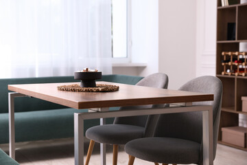 Wooden table with chairs and decor in dining room. Interior design