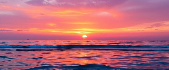 Fiery orange and purple sunset reflecting on calm ocean waves, pink, coast