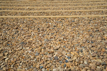 Round of  pebbles or gravel river background. Variety of smooth, natural rocks with different shapes and textures for  arranged very beautifully in nature of gardening.