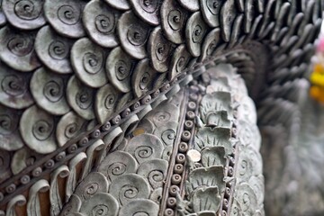 The scales of a large dragon at a Buddhist temple, where people go to pray for luck in the lottery.